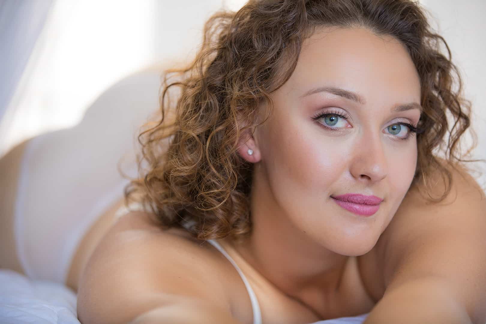 boudoir image of woman smiling confidently